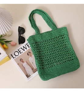 Detail of green woven tote bag with openwork texture and minimalist summer design