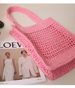 Detailed macro view of pink hollow woven tote bag with intricate crochet mesh texture