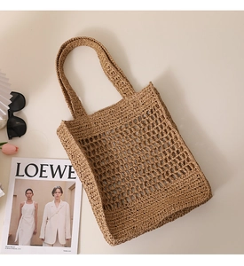 Detailed texture of hand-woven straw tote bag with mesh hollow design for summer