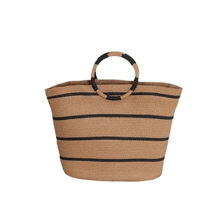 Large striped straw tote bag with round handles for beach vacations and summer travel