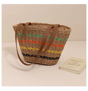 Close-up of a woven straw tote bag with vibrant colored stripes and leather handles