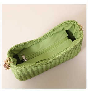 Macro detail of purple straw tote bag interior with green lining and metal zipper