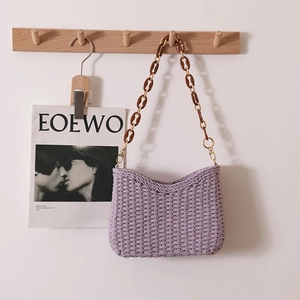 Chic purple woven tote bag with amber acrylic chain strap for beach vacations