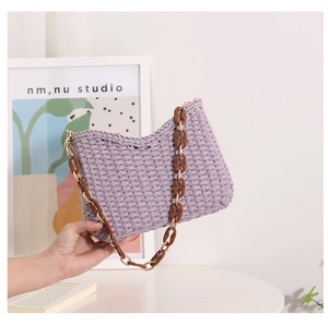 Close-up of handmade purple woven tote bag featuring a chunky brown chain shoulder strap