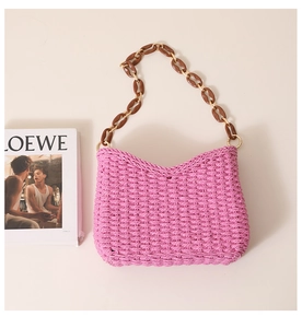 Detail of pink woven texture with resin chain strap on a stylish summer tote bag