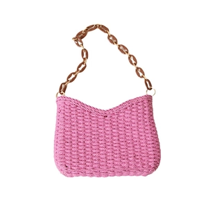 Pink woven straw tote bag with brown resin chain shoulder strap for beach vacation