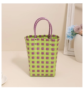 Detail of woven tote bag showing green and purple checkerboard pattern and metal rivets