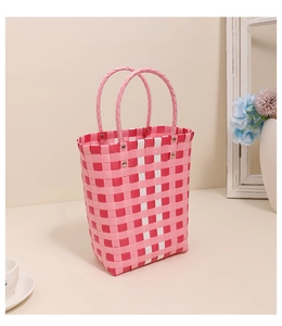 Detail of pink and white checkered woven basket showing metal rivets and handles