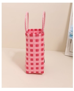 Detail of hand-woven pink checkered pattern on a rectangular plastic tote bag