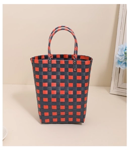 Detail of red and blue checkered woven plastic tote bag with metal rivet reinforcement