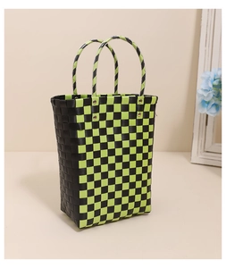 Detail of handwoven black and green checkered tote bag with reinforced double handles