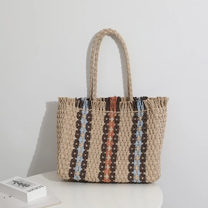 Vertical striped straw tote bag with colorful lines and fringed edge for beach vacation