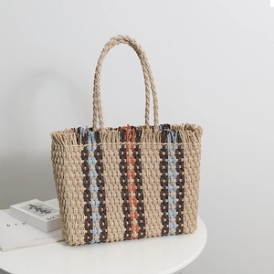 Vertical striped straw tote bag with tassels and bohemian woven texture for beach vacation