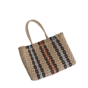 Vertical stripe straw tote bag with woven handles for summer beach vacations
