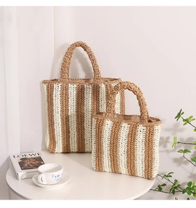 Detailed view of striped woven straw tote bags with fabric lining and sturdy handles
