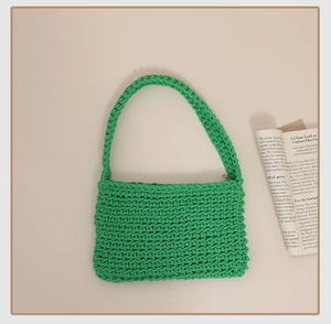 Detailed close-up of vibrant green hand-woven cotton rope bag with zip closure