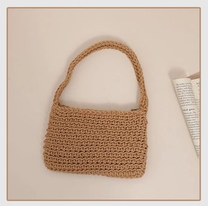 Macro detail of khaki crochet shoulder bag showing tight knit texture and rectangular design