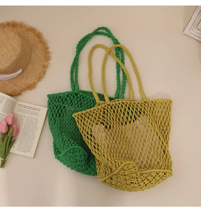 Detail view of woven cotton rope shoulder bags in green and ginger with linen lining