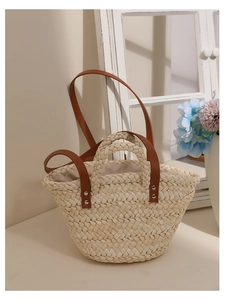 Detail of woven corn husk bag with leather handles and metallic rivet reinforcement