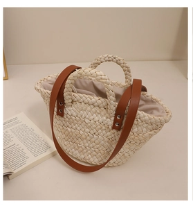 Detailed view of handmade corn husk tote bag with leather straps and drawstring liner