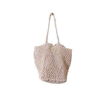 Large beige woven cotton mesh shoulder bag for beach vacations and casual style