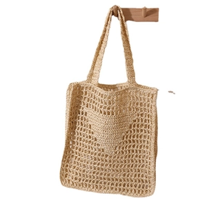 Beige crochet straw shoulder bag with heart pattern for summer beach holiday