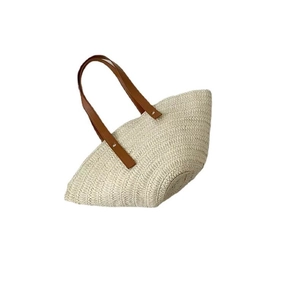 Handmade half-moon straw tote bag with brown leather handles for summer beach holidays