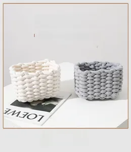 Detailed texture of thick cotton rope woven storage baskets in beige and gray colors