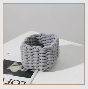Detail of a gray braided cotton rope storage basket with thick handcrafted texture