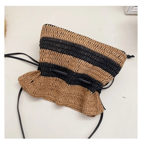Detailed macro view of striped straw woven bag with texture and drawstring closure