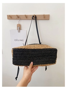 Detail showing the two-tone woven texture and solid rectangular base of the straw tote bag