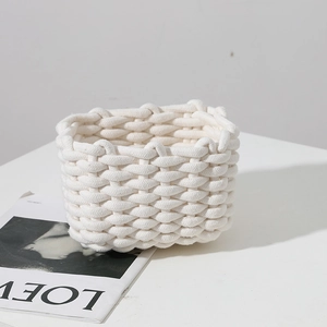 Minimalist cream woven cotton rope storage basket for desktop organization and makeup