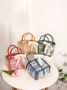 Macro detail of woven jelly bags with lace bows in pink, yellow, green and blue