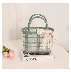 Detail of green woven basket bag with lace bow accessory and check pattern texture
