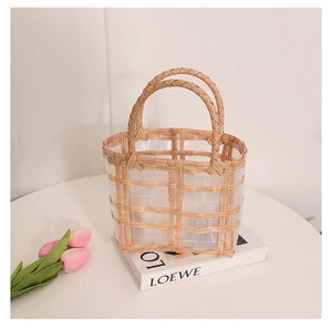 Detail of woven jelly basket bag with lace bow and dual handles for beach vacation