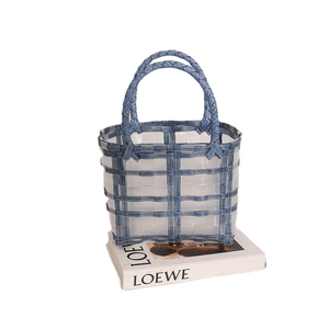 Transparent jelly weave tote bag with blue denim accents and sturdy woven handles