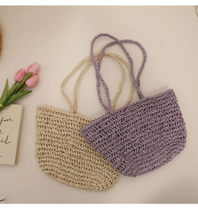 Flat lay of cream and lavender woven straw bags with tulips and decorative books