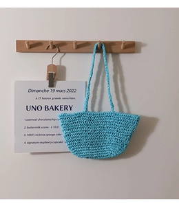 Detailed close-up showing the hollow knit texture of this blue summer crochet beach bag