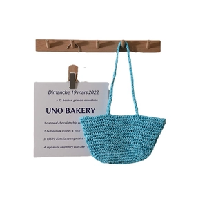 Light blue woven straw shoulder tote bag with herringbone pattern for beach vacation