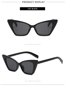Detail view of black cat eye sunglasses featuring polished frames and dark grey lenses