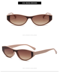 Détail de lunettes de soleil œil de chat beige avec verres dégradés marron et monture