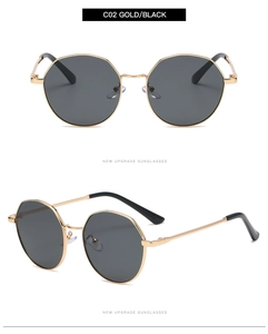 Detail view of gold octagonal sunglasses with gradient black lenses and thin metal frame