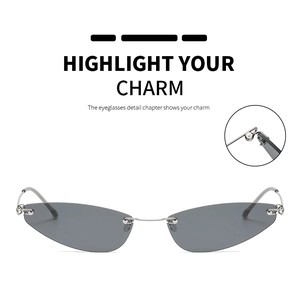Detail view of rimless cat-eye sunglasses featuring metal hinges and grey tinted lenses