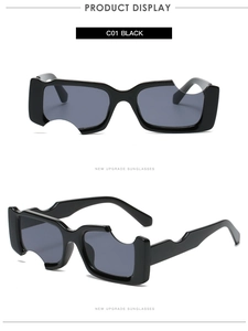 Détail de lunettes de soleil carrées noires irrégulières avec encoches et verres gris foncé