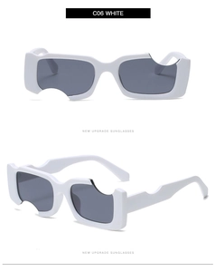 Détail des lunettes de soleil rectangulaires blanches avec découpes circulaires sur le cadre
