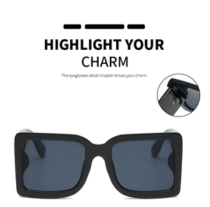 Detail view of square sunglasses hinge and glossy black oversized fashion frame