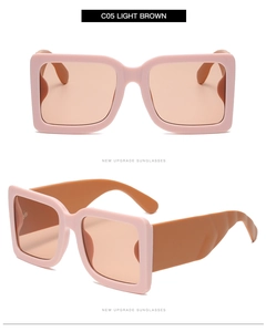Detail of square oversized sunglasses showing bicolor pink frame and brown wide temples