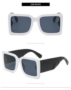 Detail view of white wide-frame square sunglasses with grey lenses and wavy temples