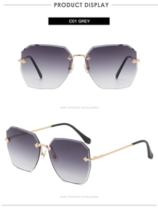 Détail de lunettes de soleil géométriques sans monture avec verres dégradés et branches dorées