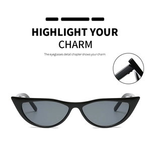 Detail view of cat-eye sunglasses featuring robust metal hinges and sleek black frames